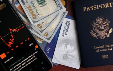 Stock trading concepts with passport, credit cards, cash, and smartphone app image.