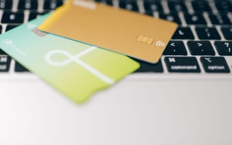 Two credit cards placed on a laptop keyboard highlighting online payment concept.